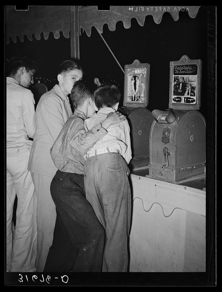 Boys looking at penny movies at South Louisiana State Fair. Donaldsonville, Louisiana by Russell Lee