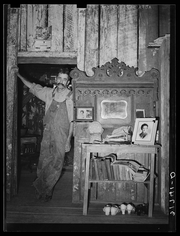 W.E. Smith, farmer near Morganza, Louisiana, in his home by Russell Lee