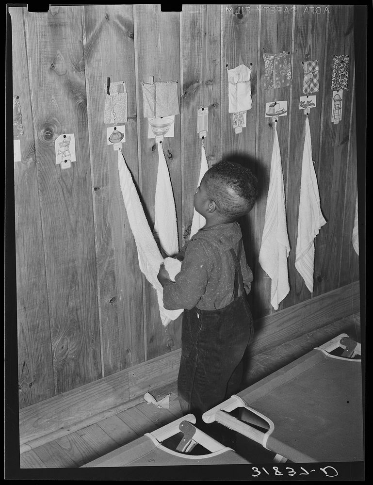  child wiping hands after washing. Note toothbrush and comb for every child. Lakeview nursery school. Arkansas by Russell Lee
