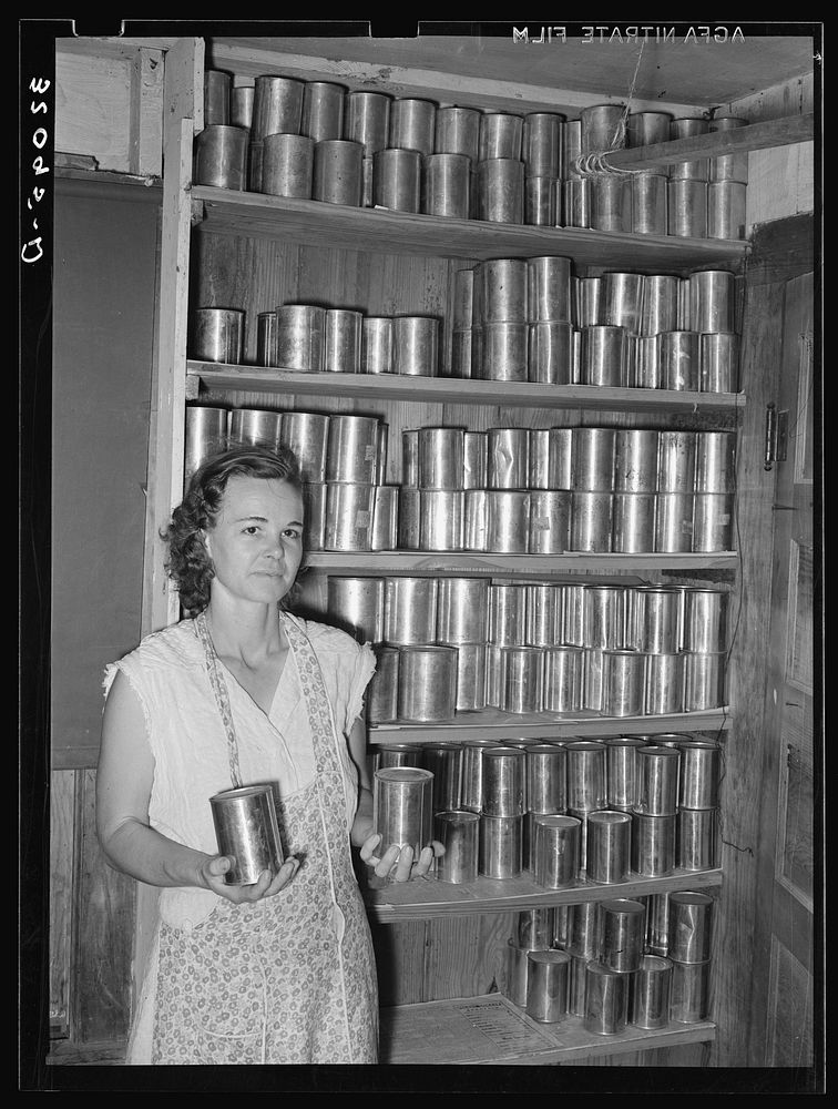 Wife of FSA (Farm Security Administration) client with canned goods. Hidalgo County, Texas by Russell Lee