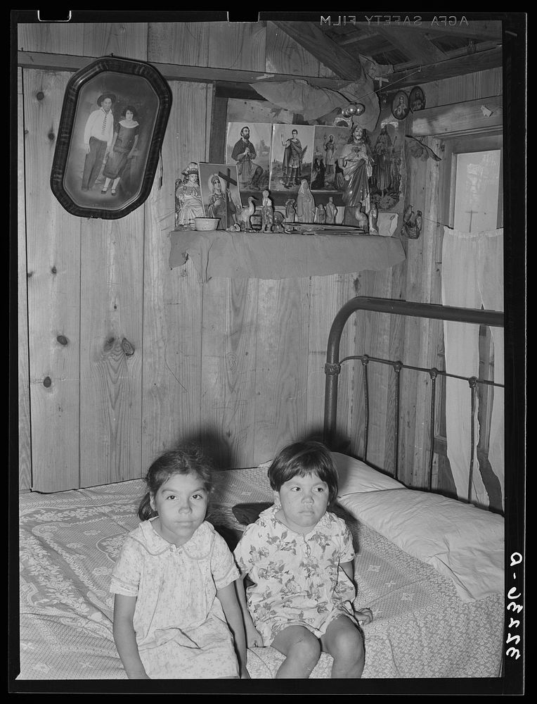 Children of Mexican labor contractor in their home. Robstown, Texas. Note the shrine above the children. These shrines, many…
