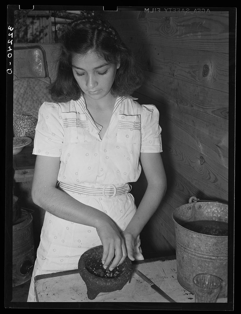 Mexican girl grinding peppers. Robstown, Texas by Russell Lee