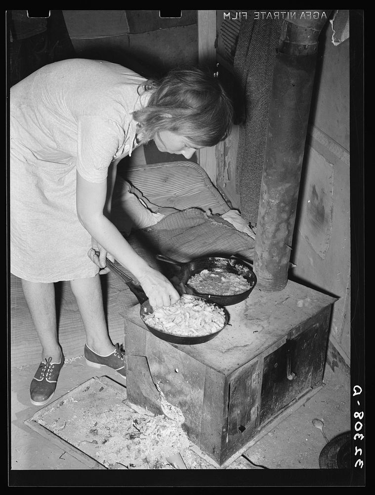 White migrant woman cooking cabbage in tent home. Edinburg, Texas by Russell Lee