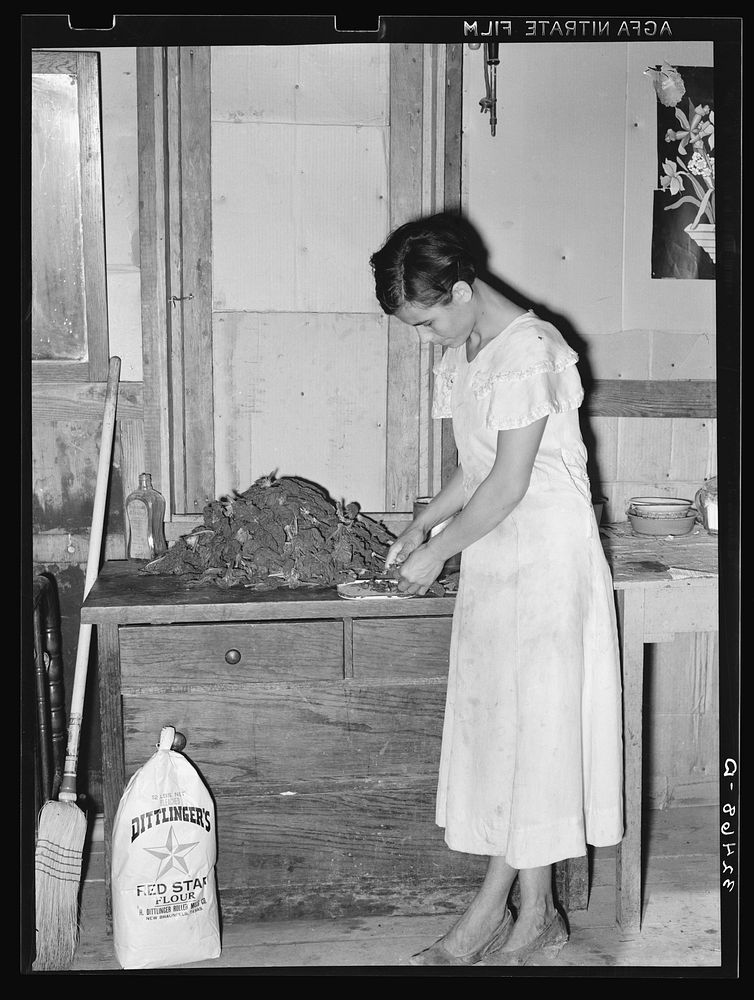 Mexican woman preparing spinach. San Antonio, Texas. The spinach was a part of her relief commodities by Russell Lee