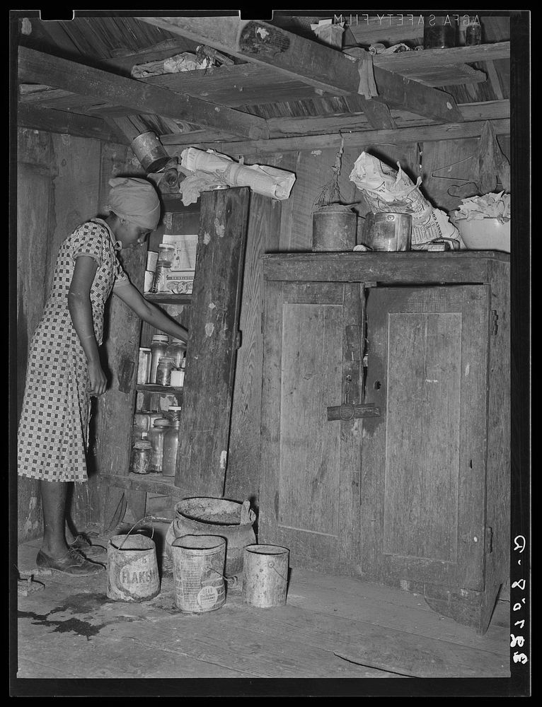  woman living on farm near Jefferson, Texas, preparing dinner by Russell Lee