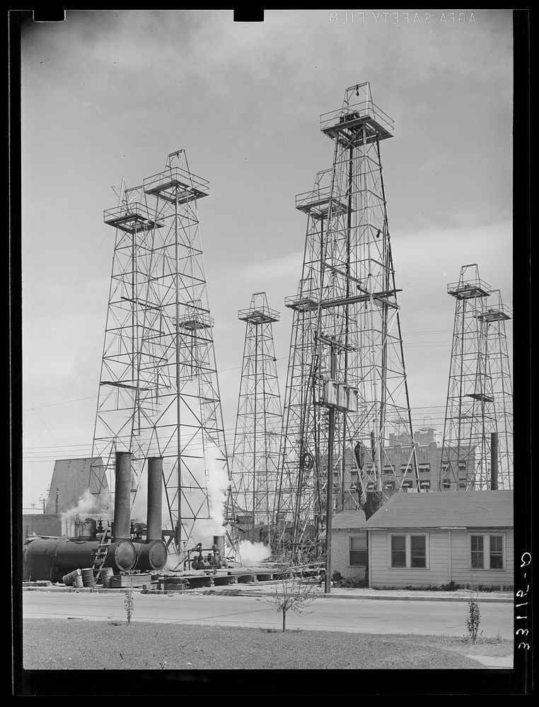 Drilling operations and derricks. Kilgore, Texas by Russell Lee