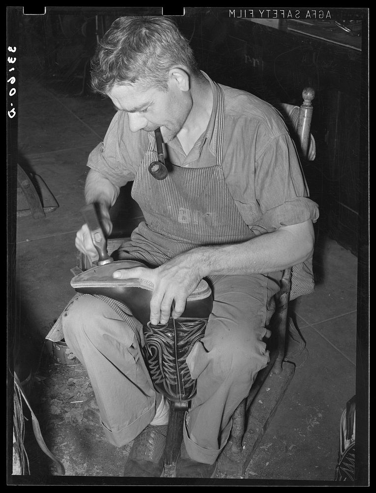 Bootmaker shaping the outer sole to the boot. Cowboy boot shop, Alpine, Texas by Russell Lee