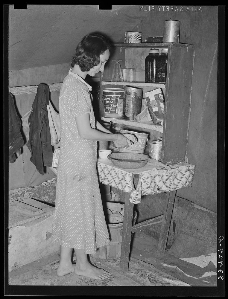 Wife of day laborer in kitchen in camp in Arkansas River bottom near Webbers Falls, Oklahoma. Muskogee County by Russell Lee