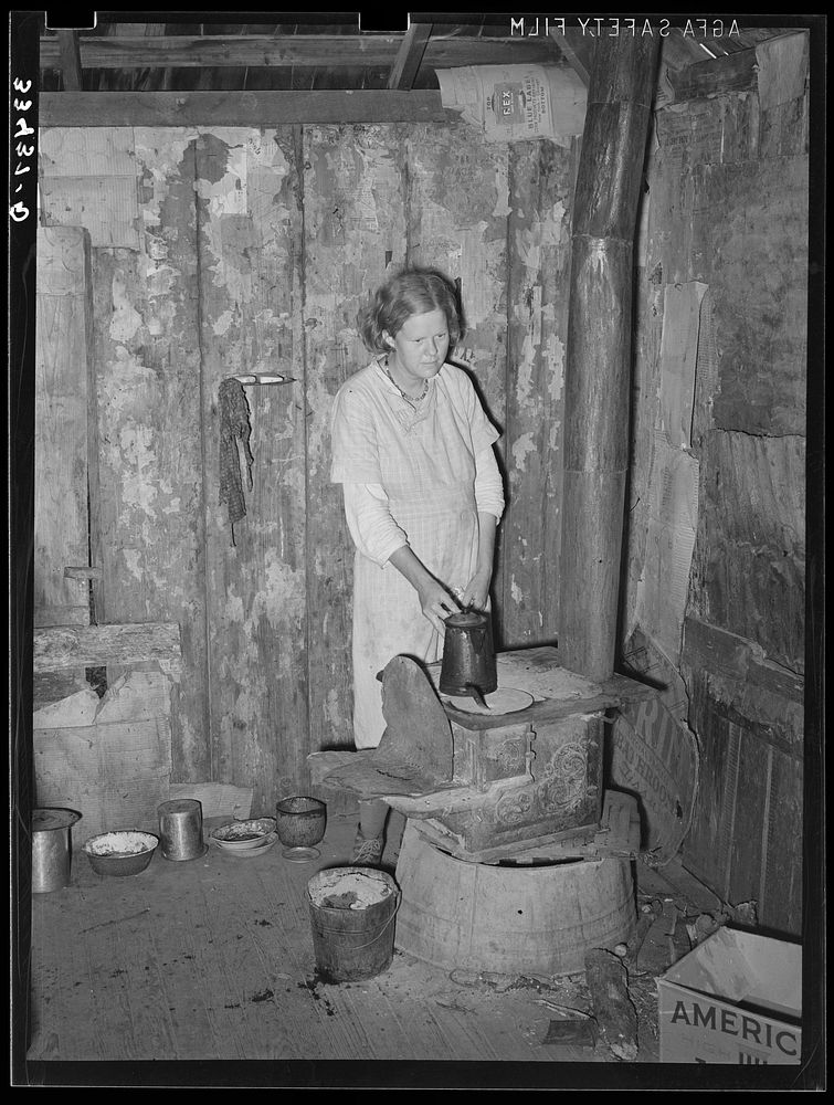 Wife of day laborer in kitchen corner of one-room shack near Warner, Oklahoma. Muskogee County by Russell Lee