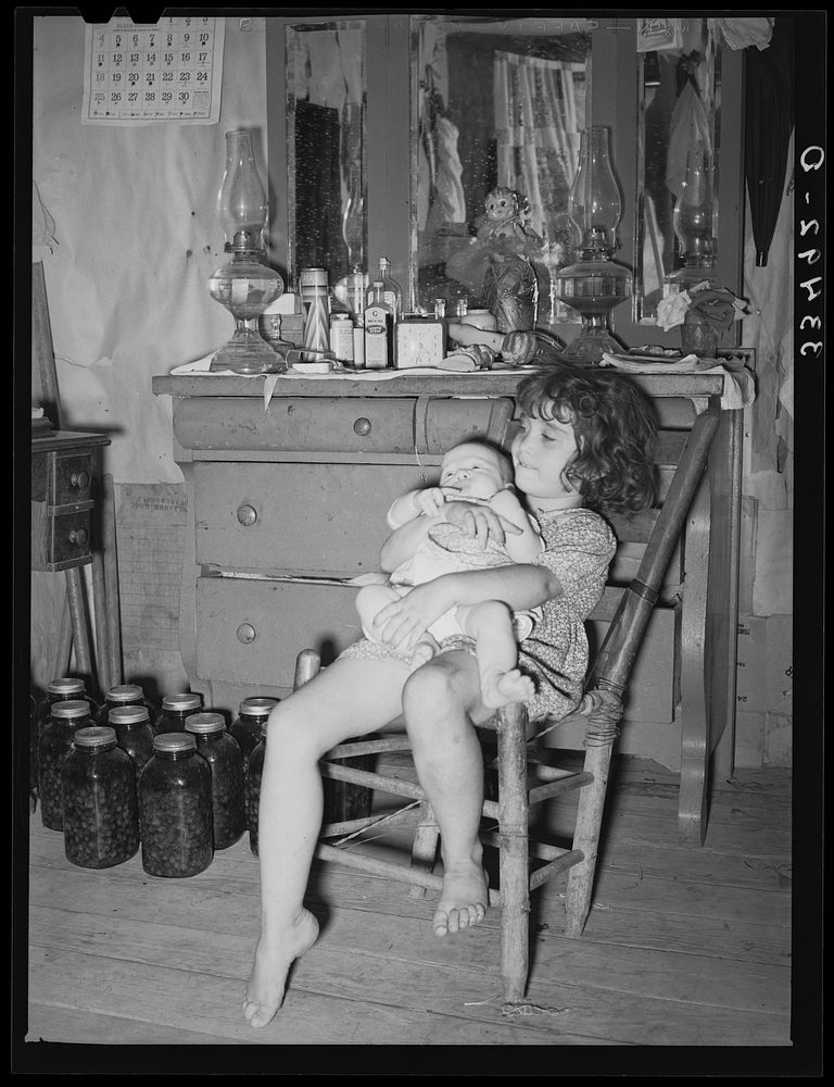Daughter of white tenant farmer taking care of her baby sister in her home in McIntosh County, Oklahoma by Russell Lee