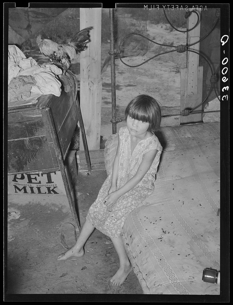 Daughter of agricultural day laborer and his tubercular wife in bedroom of shack home on Poteau Creek near Spiro, Oklahoma…