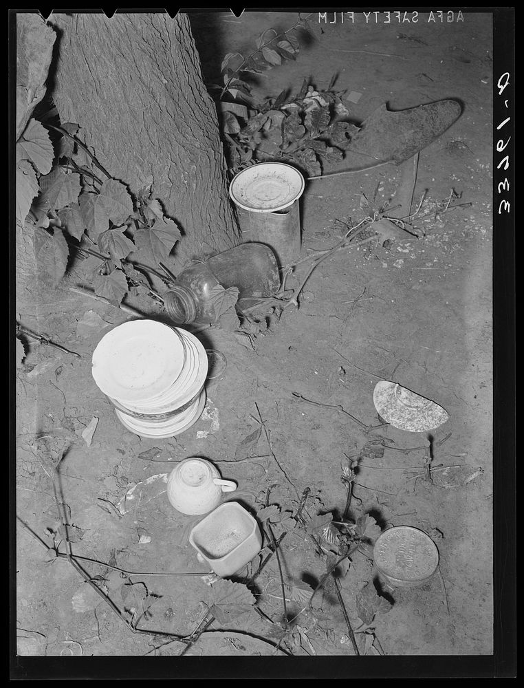 Dishes left by the migrant family at their homestead near Muskogee, Oklahoma by Russell Lee