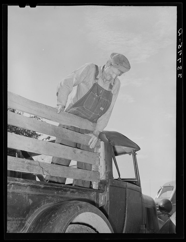 Elmer Thomas, migrant to California, standing on the body of his improvised truck before leaving for California. Near…