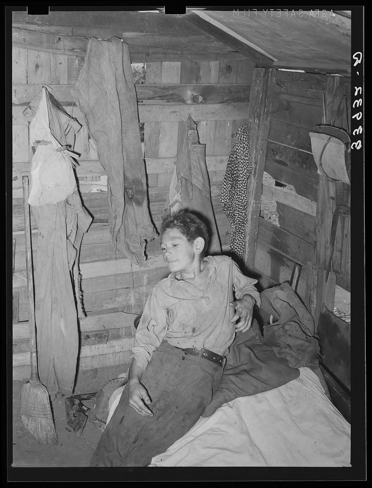 Boy in corner of shack home near Mays Avenue. Oklahoma City, Oklahoma by Russell Lee