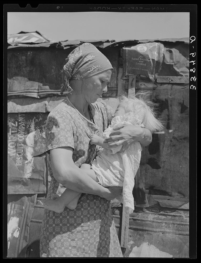 Mother and child in front of shack in Mays Avenue camp. Oklahoma City, Oklahoma. Refer to general caption no. 21 by Russell…