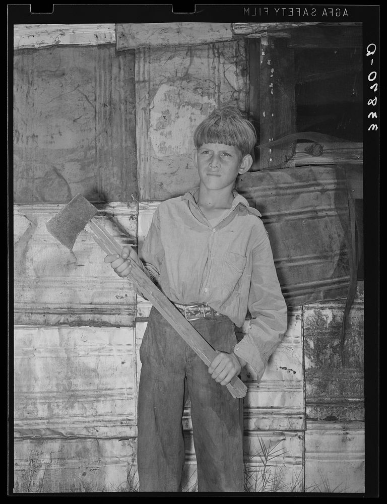 Boy living in Mays Avenue camp with homemade ax. Oklahoma City, Oklahoma. Refer to general caption no. 21 by Russell Lee