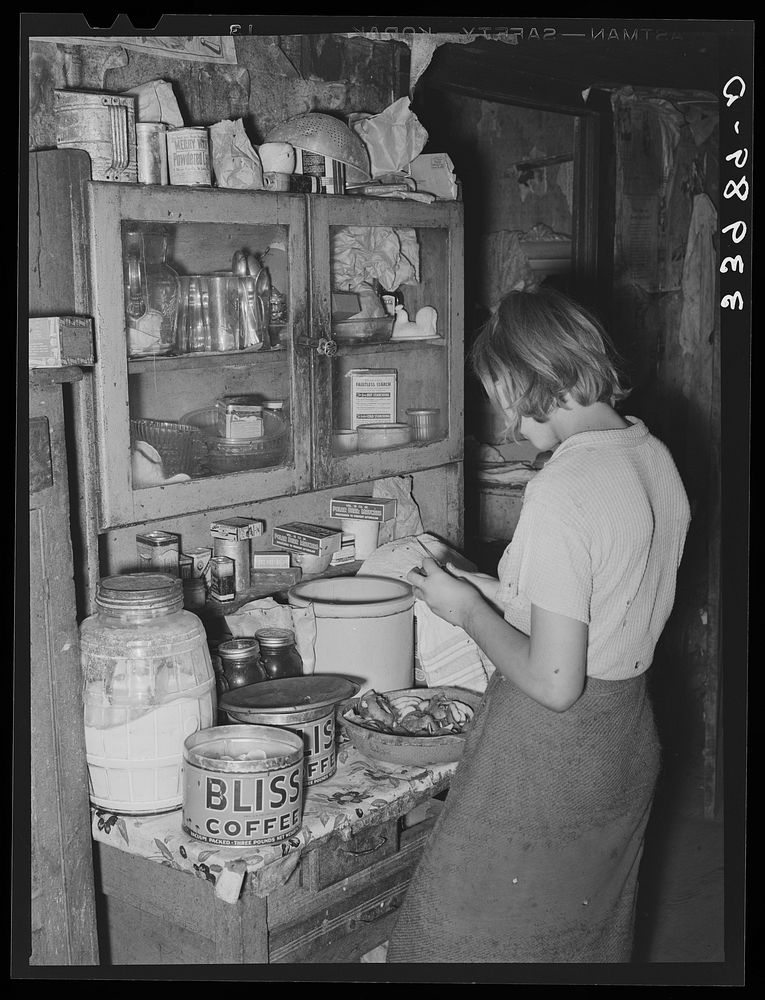 Daughter of tenant farmer peeling potatoes for noonday meal, near Muskogee, Oklahoma. See general caption 20 by Russell Lee