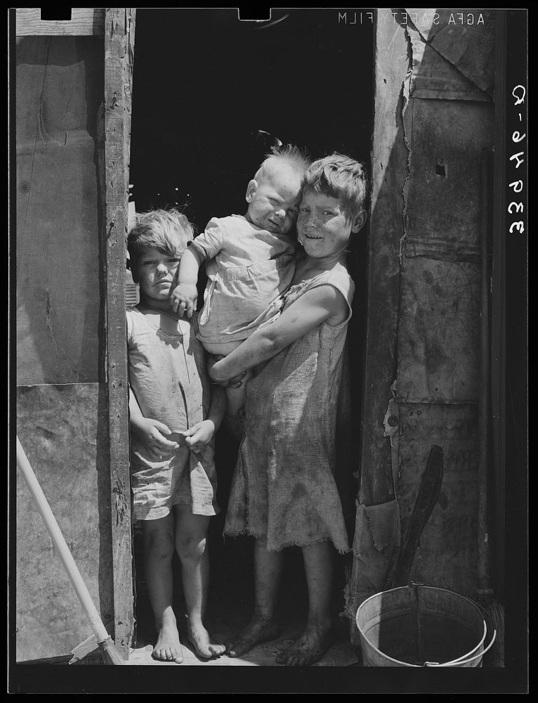 [Untitled photo, possibly related to: Children of Mays Avenue camp dressed in old sacks. Their father is a "trasher."…