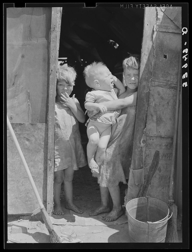 [Untitled photo, possibly related to: Children of Mays Avenue camp dressed in old sacks. Their father is a "trasher."…