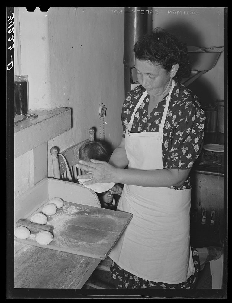 Tortillas being shaped after they have been rolled flat. Spanish-American home near Taos, New Mexico, Taos County by Russell…
