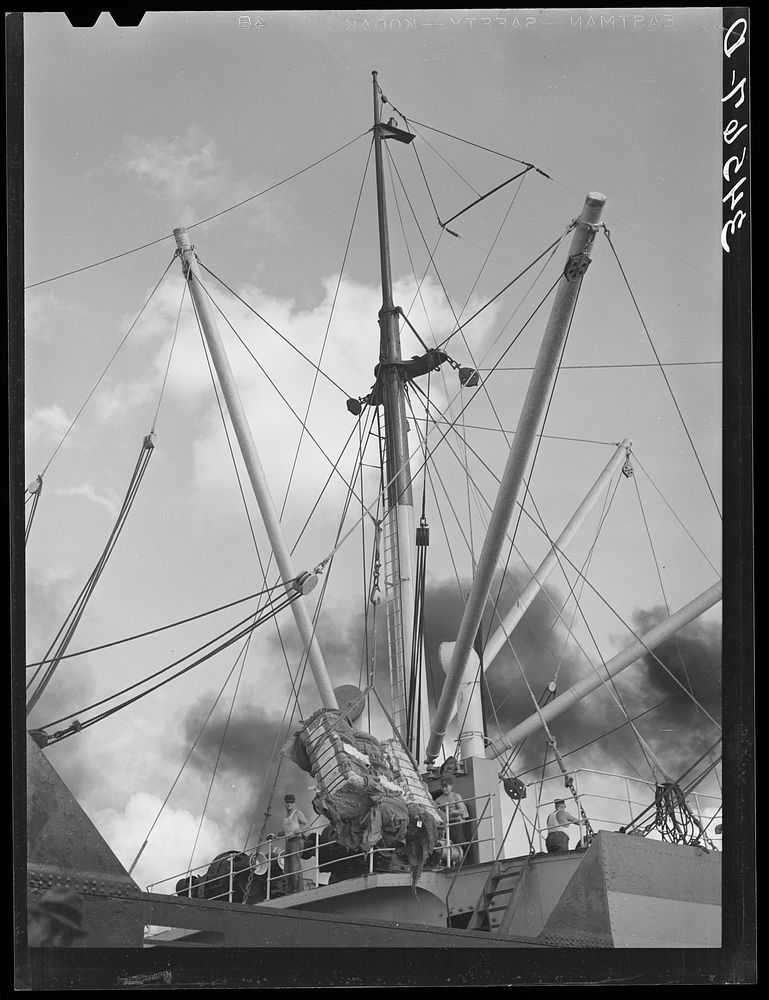 Loading of cotton for export. Notice man operating winch. Port of Houston, Texas by Russell Lee