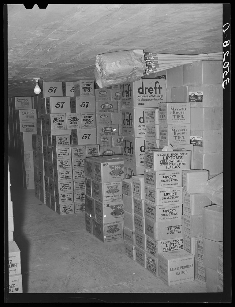 Cartons of groceries in storage at wholesale grocery. San Angelo, Texas by Russell Lee