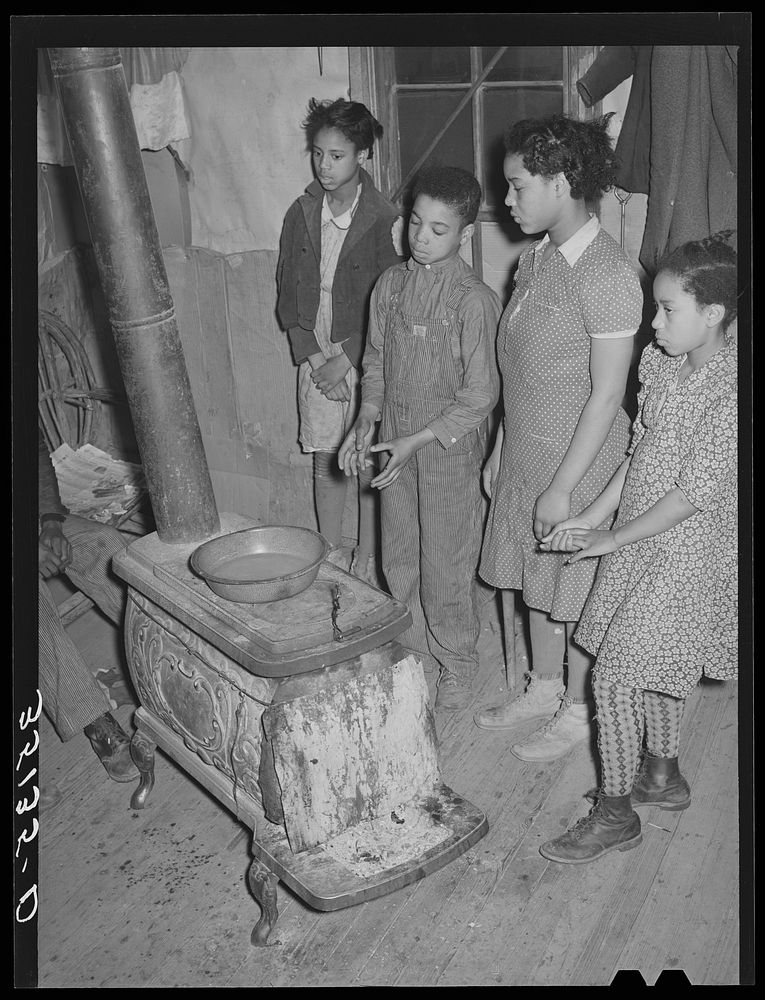 Children of Pomp Hall,  tenant farmer, standing by stove. Creek County, Oklahoma by Russell Lee