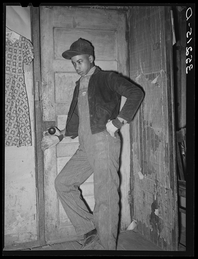 [Untitled photo, possibly related to: Son of Pomp Hall, tenant farmer, coming through doorway in his house. Creek County…