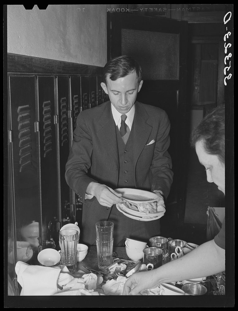 Jaycee member helping clean up the dishes after supper at high school. Eufaula, Oklahoma. See general caption number 25 by…