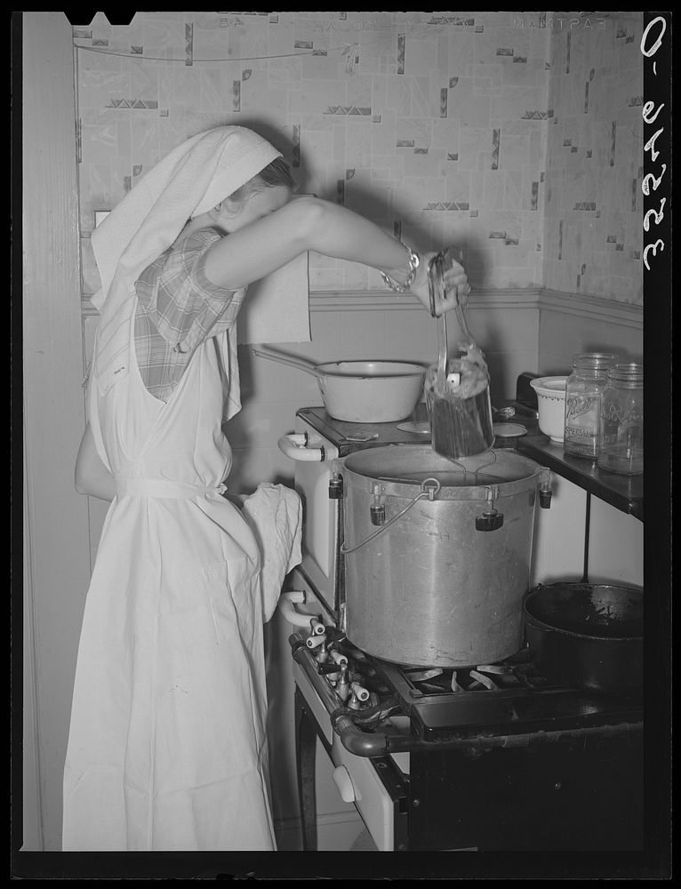 FSA (Farm Security Administration) supervisor demonstrating canning with a pressure cooker before a group of FSA supervisors…