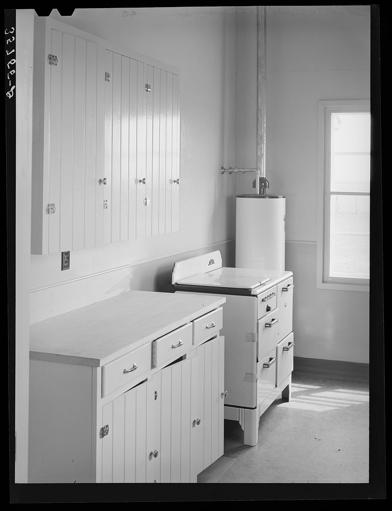 Kitchen in the community building at the migratory labor camp. Robstown, Texas by Russell Lee