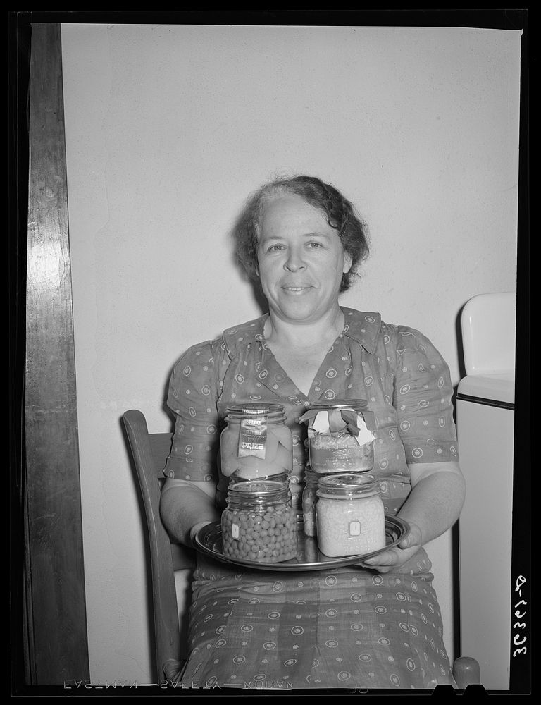 Wife of member of the Casa Grande Valley Farms, displaying canned goods with which she won prizes at the state fair. Pinal…