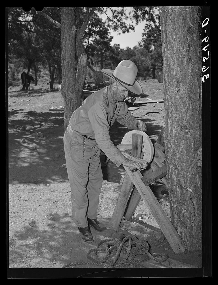 Faro Caudill's father sharpening his knife. This man was a cowboy and rancher in the section before the homesteaders came…