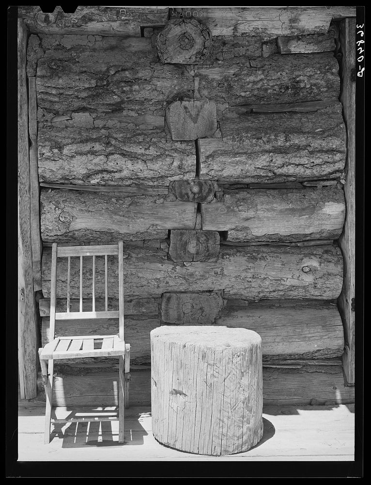 Construction detail of log house showing how logs which form an interior partition extend through the outside walls. Pie…