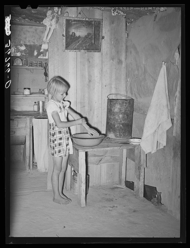 Jack Whinery's daughter washing her hands before dinner. Pie Town, New Mexico by Russell Lee