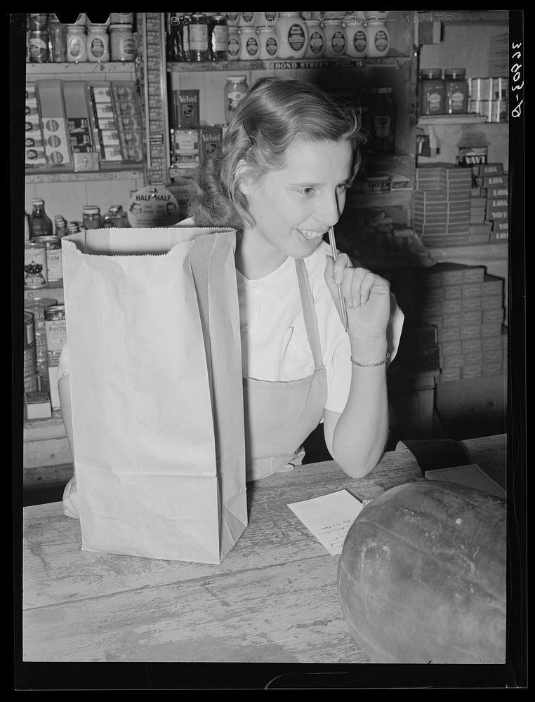 Clerk in the commissary. Mogollon, New Mexico by Russell Lee