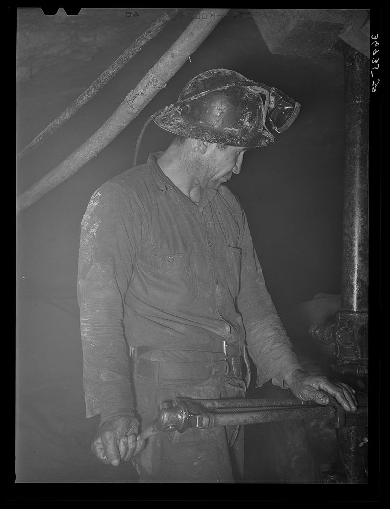 Gold miner operating pneumatic drill. Mogollon, New Mexico by Russell Lee