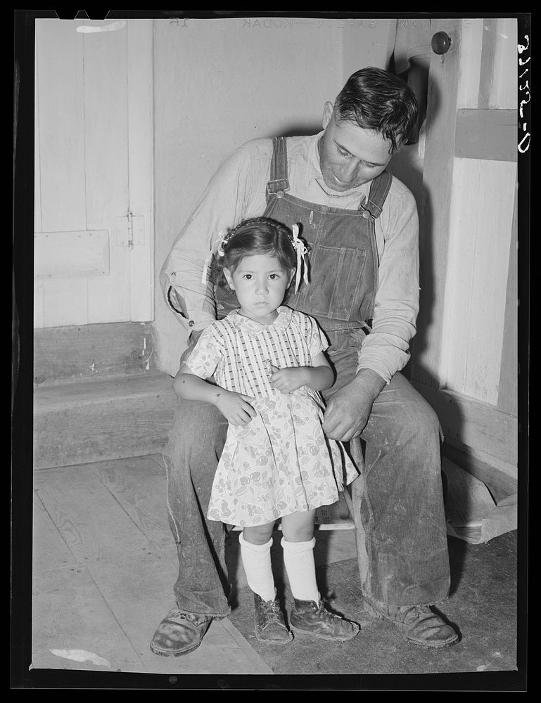 Spanish-American farmer with his daughter. Chamisal, New Mexico by Russell Lee