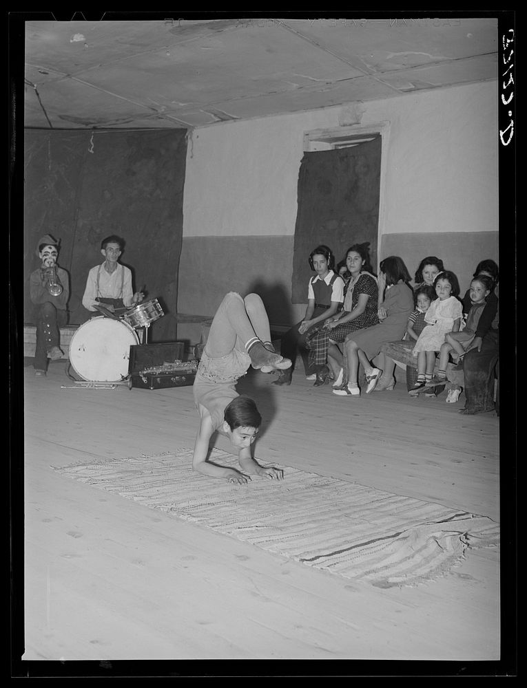 Acrobat and audience at Spanish-American traveling show. Penasco, New Mexico by Russell Lee
