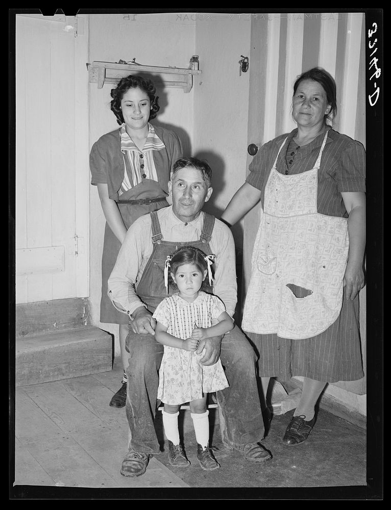 Spanish-American farmer and his family. Chamisal, New Mexico by Russell Lee