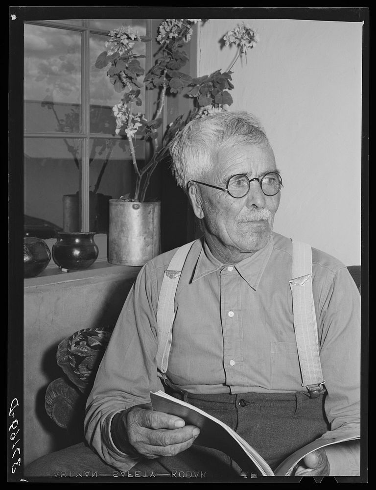 Old Spanish-American man in his home at Chamisal, New Mexico by Russell Lee
