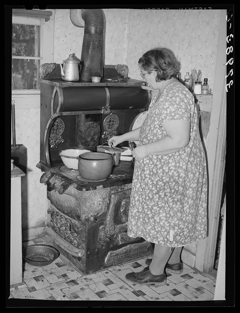 Wife of Jo Webster cooking lunch. Tehama County, California by Russell Lee