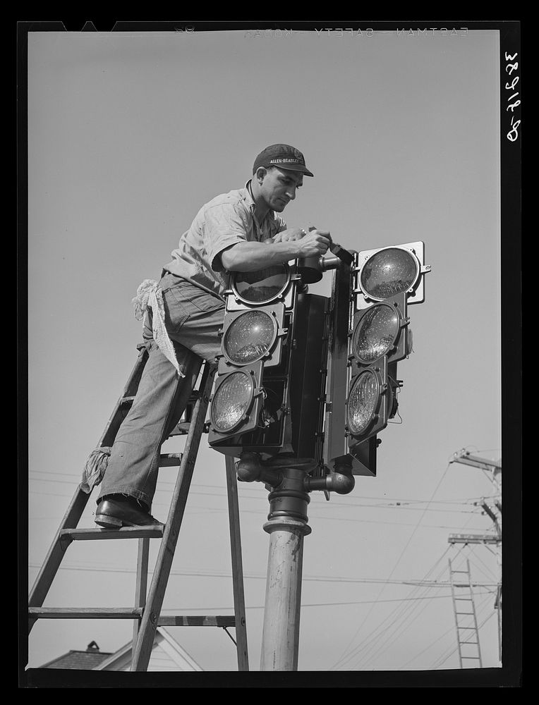 Putting up new traffic signal. San Diego, California by Russell Lee