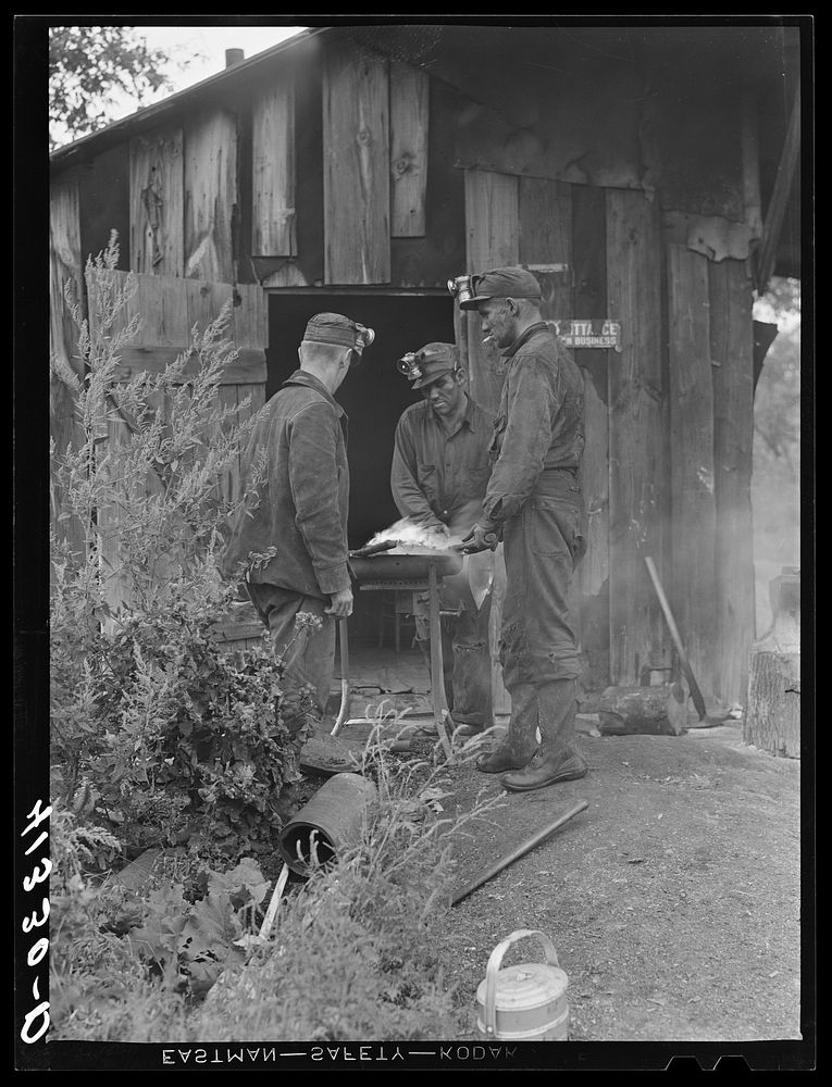 Miners at Dougherty's mine, near Falls Creek, Pennsylvania, sharpening their axes at the end of a day's work. Sourced from…