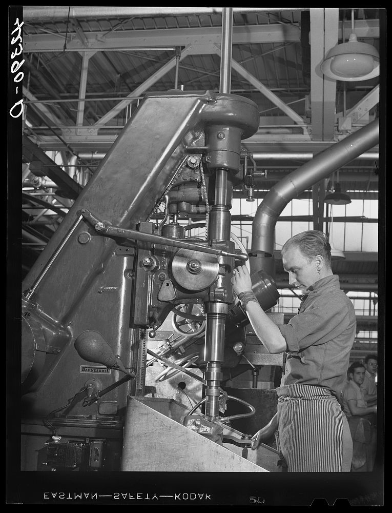 A drill press in operation at the Pratt and Whitney Aircraft Corporation. East Hartford, Connecticut. Sourced from the…