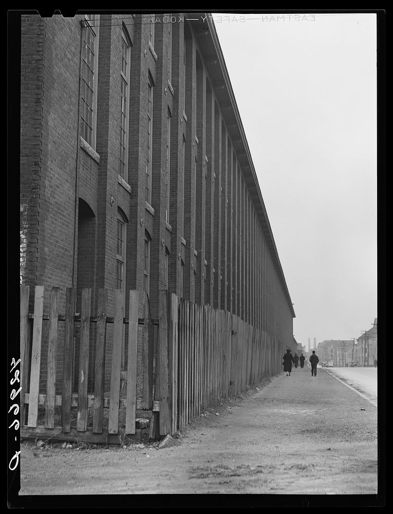 Outside of a large textile mill in New Bedford, Massachusetts. Sourced from the Library of Congress.