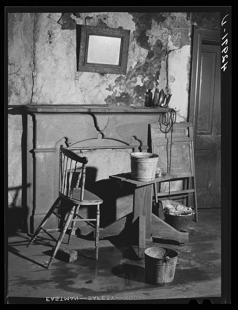 Buckets placed in room to catch water from leaky ceiling in a house in Mount Washington district. Beaver Falls…