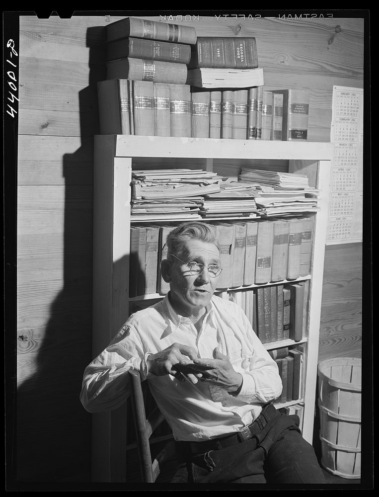 Mr. J. H. Parham, barber and notary public, in his shop in Centralhatchee, Heard County, Georgia. Sourced from the Library…