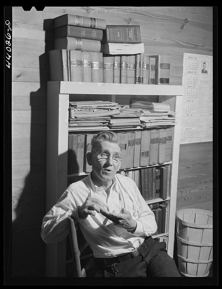 [Untitled photo, possibly related to: Mr. J. H. Parham, barber and notary public, in his shop in Centralhatchee, Heard…