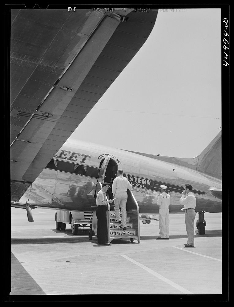 Passengers boarding a plane. Washington, D.C. municipal airport. Sourced from the Library of Congress.